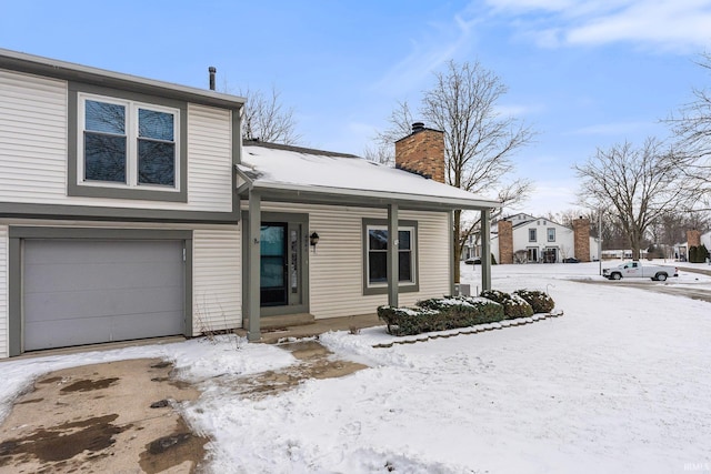 view of front of home featuring a garage and a chimney