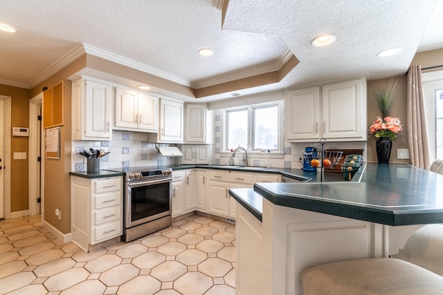 kitchen featuring dark countertops, white cabinetry, and a peninsula