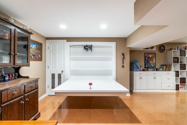 interior space with baseboards and recessed lighting