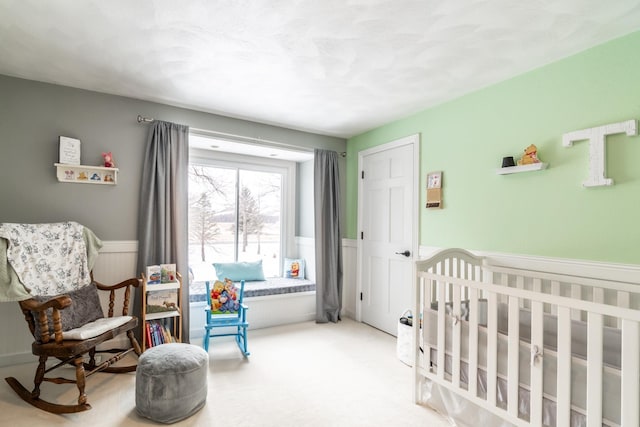 carpeted bedroom with wainscoting