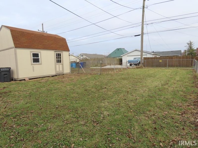 view of yard with an outbuilding and fence