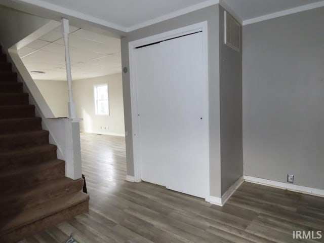 interior space with visible vents, baseboards, stairs, dark wood finished floors, and crown molding