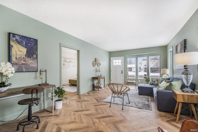 living area featuring a textured ceiling and baseboards