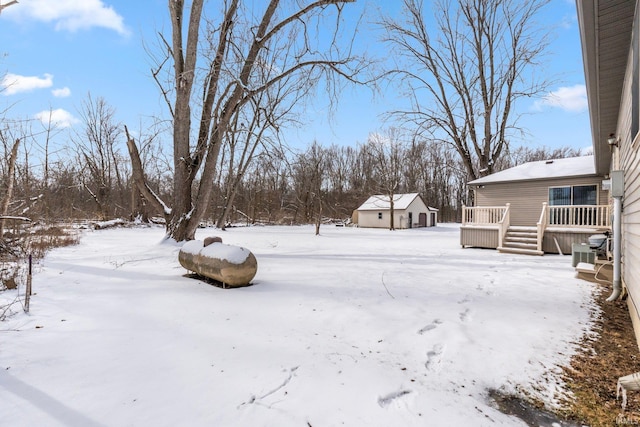 yard layered in snow with a wooden deck