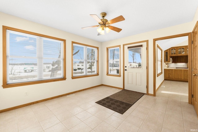 foyer with a ceiling fan, visible vents, baseboards, and light tile patterned flooring