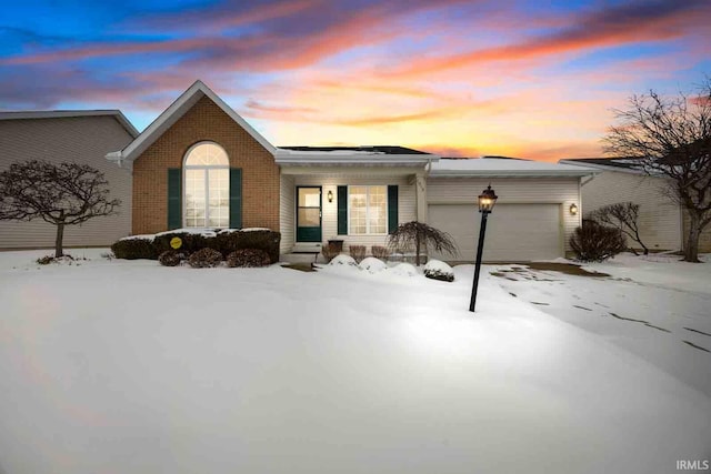 ranch-style home with a garage and brick siding