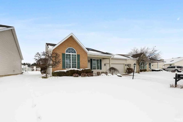 single story home with brick siding and an attached garage