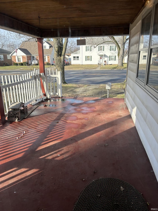 wooden terrace featuring a residential view and a porch