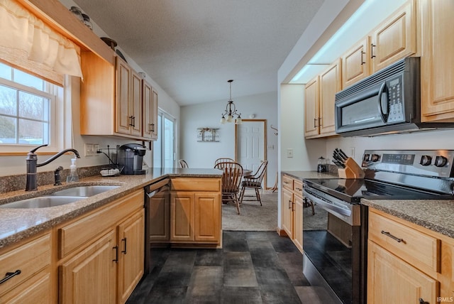 kitchen featuring hanging light fixtures, light brown cabinets, stainless steel appliances, and a sink