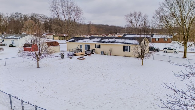 snow covered rear of property with fence and central AC unit