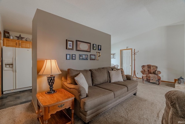 living area featuring lofted ceiling and baseboards