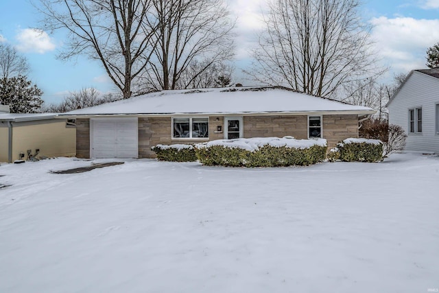 single story home featuring stone siding and an attached garage