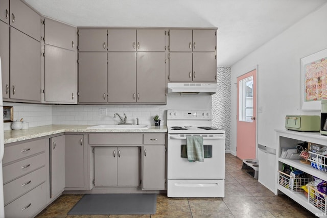 kitchen featuring white range with electric stovetop, gray cabinets, light countertops, under cabinet range hood, and a sink