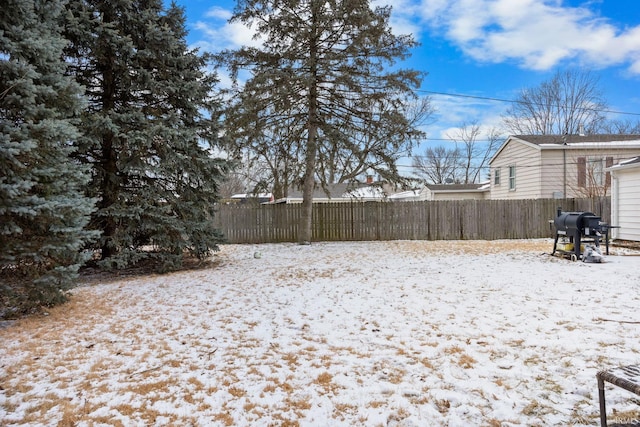 yard covered in snow with fence