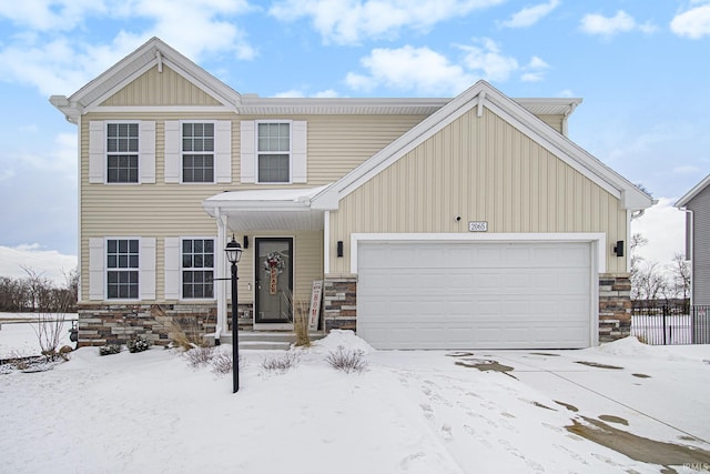 view of front of house featuring an attached garage, stone siding, fence, and board and batten siding