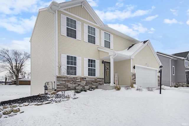 view of front of property with stone siding, board and batten siding, and a garage