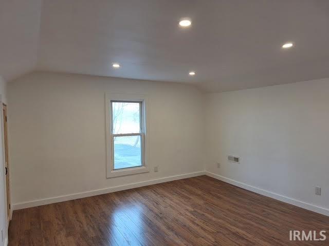 bonus room with lofted ceiling, dark wood finished floors, baseboards, and recessed lighting