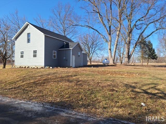 view of side of property featuring a yard