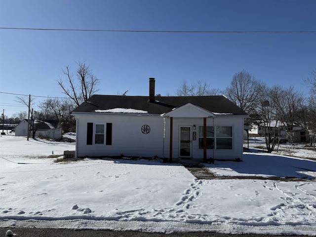 view of front of house featuring a chimney and central air condition unit