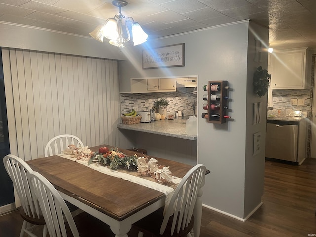 dining room featuring dark wood finished floors and baseboards