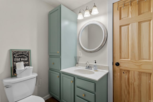 half bathroom featuring vanity and toilet