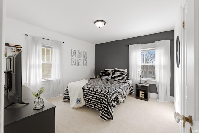 bedroom featuring carpet and baseboards