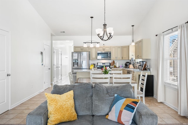 interior space with light tile patterned floors, visible vents, appliances with stainless steel finishes, and pendant lighting