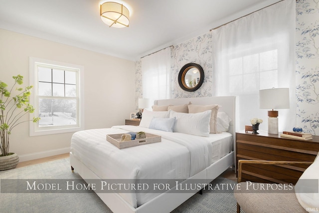 bedroom featuring wallpapered walls, light wood finished floors, and baseboards