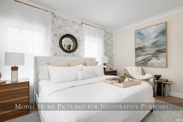 bedroom featuring crown molding and baseboards