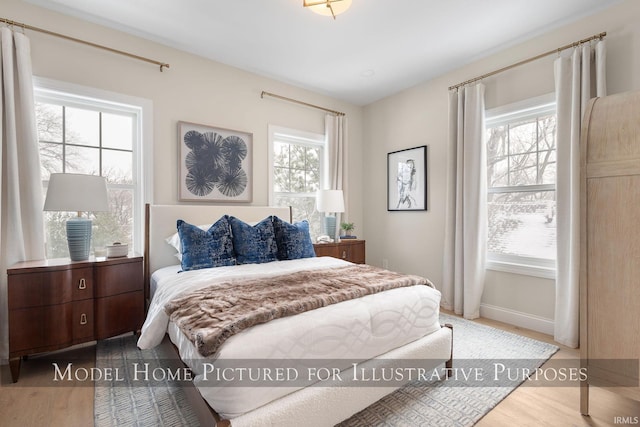 bedroom featuring wood finished floors and baseboards