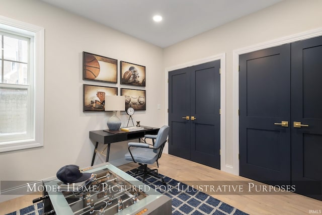 office with wood finished floors and recessed lighting