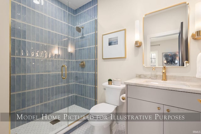 bathroom with toilet, a stall shower, and vanity