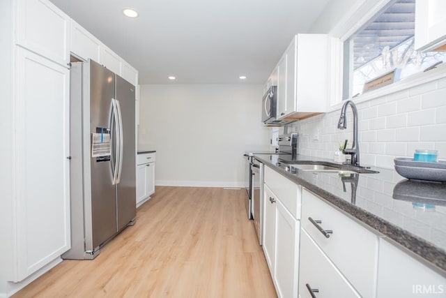 6400 Jefferson Ave, Evansville, IN 47715 - kitchen with appliances with stainless steel finishes, dark stone counters, white cabinets, and a sink