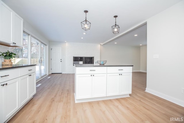 6400 Jefferson Ave, Evansville, IN 47715 - kitchen with open floor plan, dark countertops, white cabinets, and pendant lighting