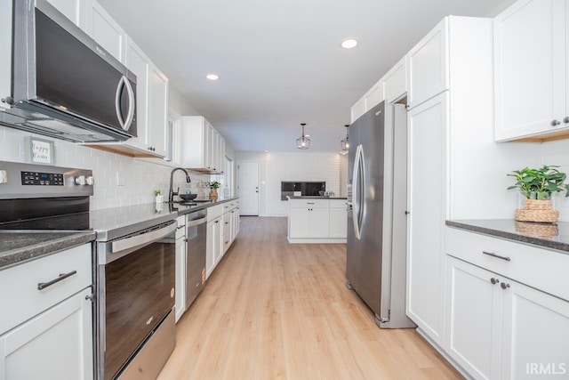 6400 Jefferson Ave, Evansville, IN 47715 - kitchen with stainless steel appliances, a sink, light wood-style flooring, and white cabinets