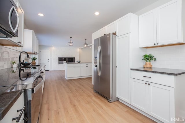 6400 Jefferson Ave, Evansville, IN 47715 - kitchen featuring white cabinetry, appliances with stainless steel finishes, and light wood-style flooring