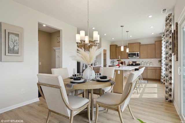 8973 Belmont Woods, Fort Wayne, IN 46835 - dining area featuring recessed lighting, visible vents, baseboards, light wood-style floors, and an inviting chandelier