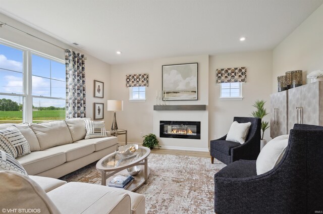 8973 Belmont Woods, Fort Wayne, IN 46835 - living area featuring light wood-type flooring, recessed lighting, baseboards, and a glass covered fireplace