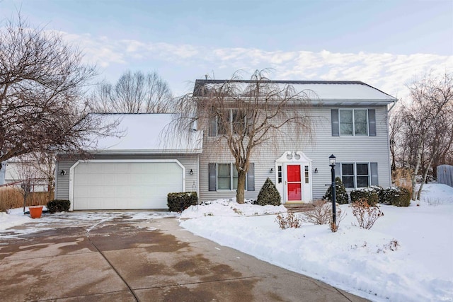 colonial home with driveway and an attached garage