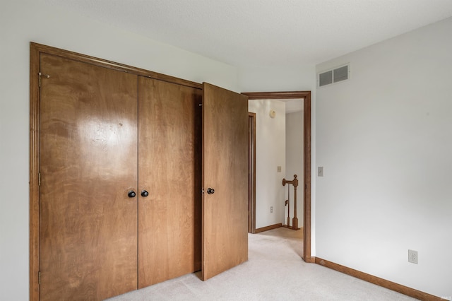 7910 Moss Grove Pl, Fort Wayne, IN 46825 - unfurnished bedroom featuring baseboards, visible vents, light carpet, and a closet
