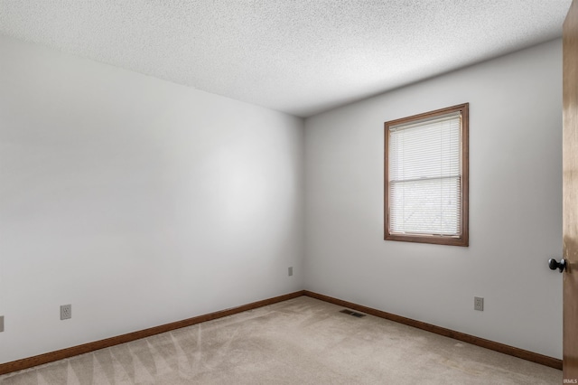 7910 Moss Grove Pl, Fort Wayne, IN 46825 - unfurnished room with visible vents, a textured ceiling, baseboards, and light carpet