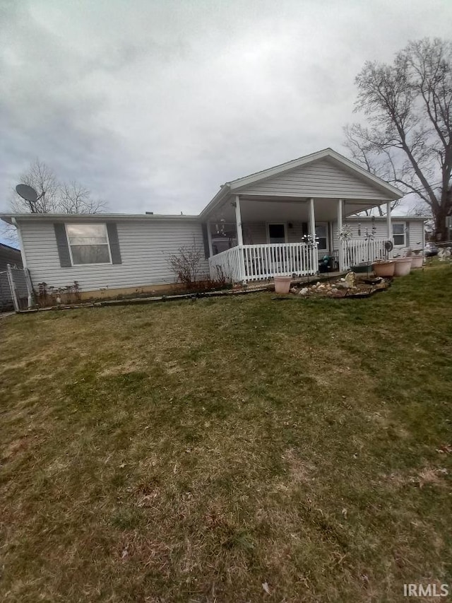 view of front of home featuring covered porch and a front lawn