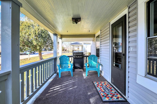 view of patio / terrace with a porch and a grill