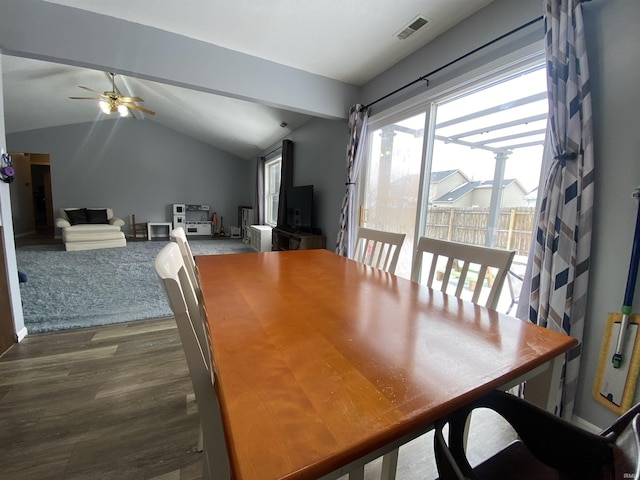 dining space featuring lofted ceiling, ceiling fan, visible vents, and dark wood-type flooring