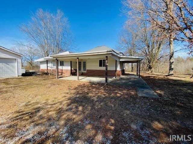 view of front of house with an attached carport and brick siding