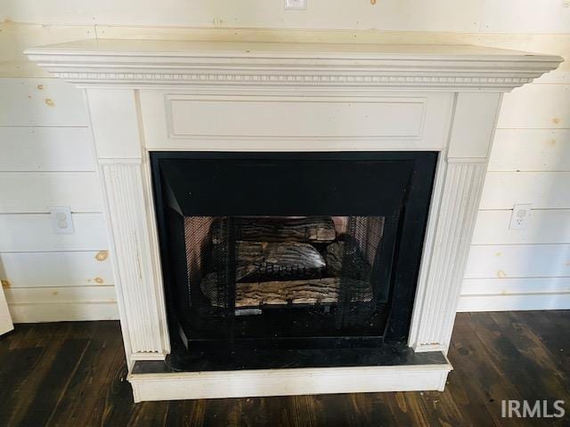 interior details featuring a fireplace and wood finished floors