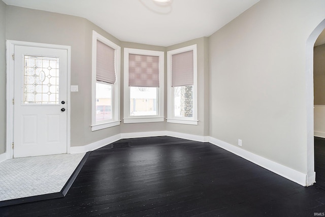 602 N Harrison St, Alexandria, IN 46001 - foyer entrance with dark wood-style floors, arched walkways, and baseboards