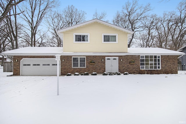 traditional-style home featuring an attached garage and brick siding