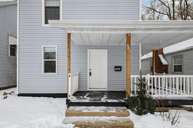 view of snow covered property entrance