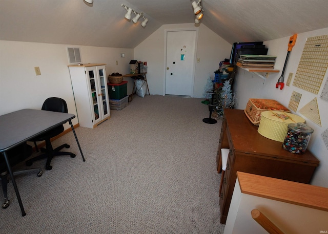 office with rail lighting, light colored carpet, vaulted ceiling, and visible vents